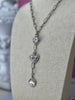 Silver Verona Lariat Necklace with cubic zircon crystal, North Star, Evil Eye, and spiked heart charms on adjustable chain